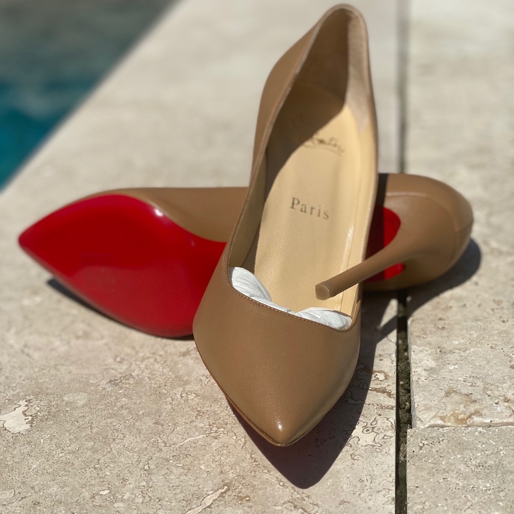 Christian Louboutin tan leather red bottom pumps.